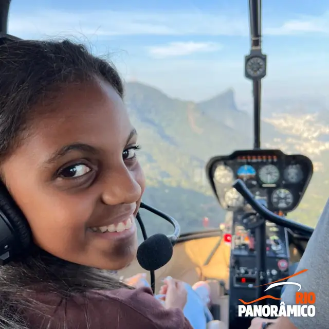 Passenger smiling in the helicopter with the city behind