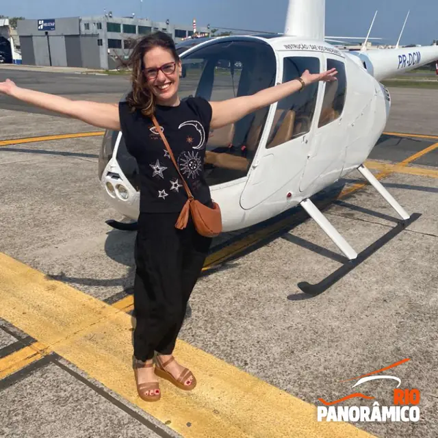 Passenger next to the helicopter on the helipad