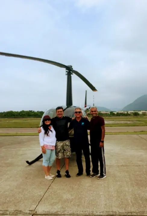 Group of passengers on the helipad before the flight